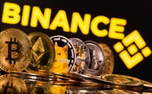 FILE PHOTO: Representations of cryptocurrencies Bitcoin, Ethereum, DogeCoin, Ripple, and Litecoin are seen in front of a displayed Binance logo in this illustration taken, June 28, 2021. REUTERS/Dado Ruvic/Illustration/File Photo