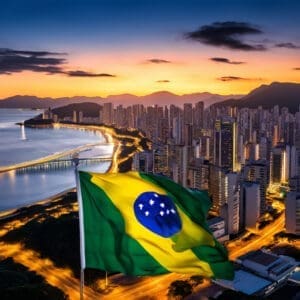 Zalazak sunca nad urbanim Brazilom, s zastavom i odsjajem u mirnoj vodi.