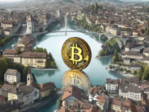 Zlatni Bitcoin simbol iznad slikovitog europskog grada uz rijeku i planine.