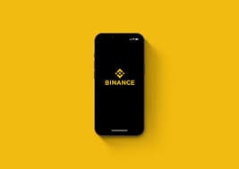 Smartphone s Binance logom na žutoj pozadini, moderni minimalistički dizajn za kripto entuzijaste. deposit eura