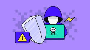 Haker u plavoj hoodici, laptop sa lubanjom, cyber sigurnost, štit i upozorenje na prijetnju.trust wallet